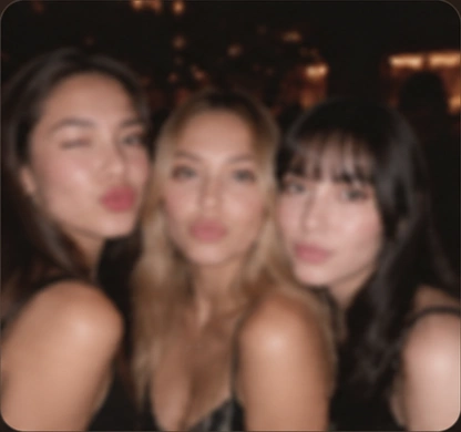A blurry group photo in dim lighting
